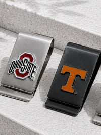 Two metal money clip holders on a speckled stone surface: one silver with an Ohio State logo and one black with a Tennessee Volunteers 'T' logo.