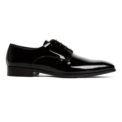 Black patent leather dress shoe on a white background