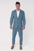 model wearing the Koi Blue Linen suit posing in different ways. No text or audio.
