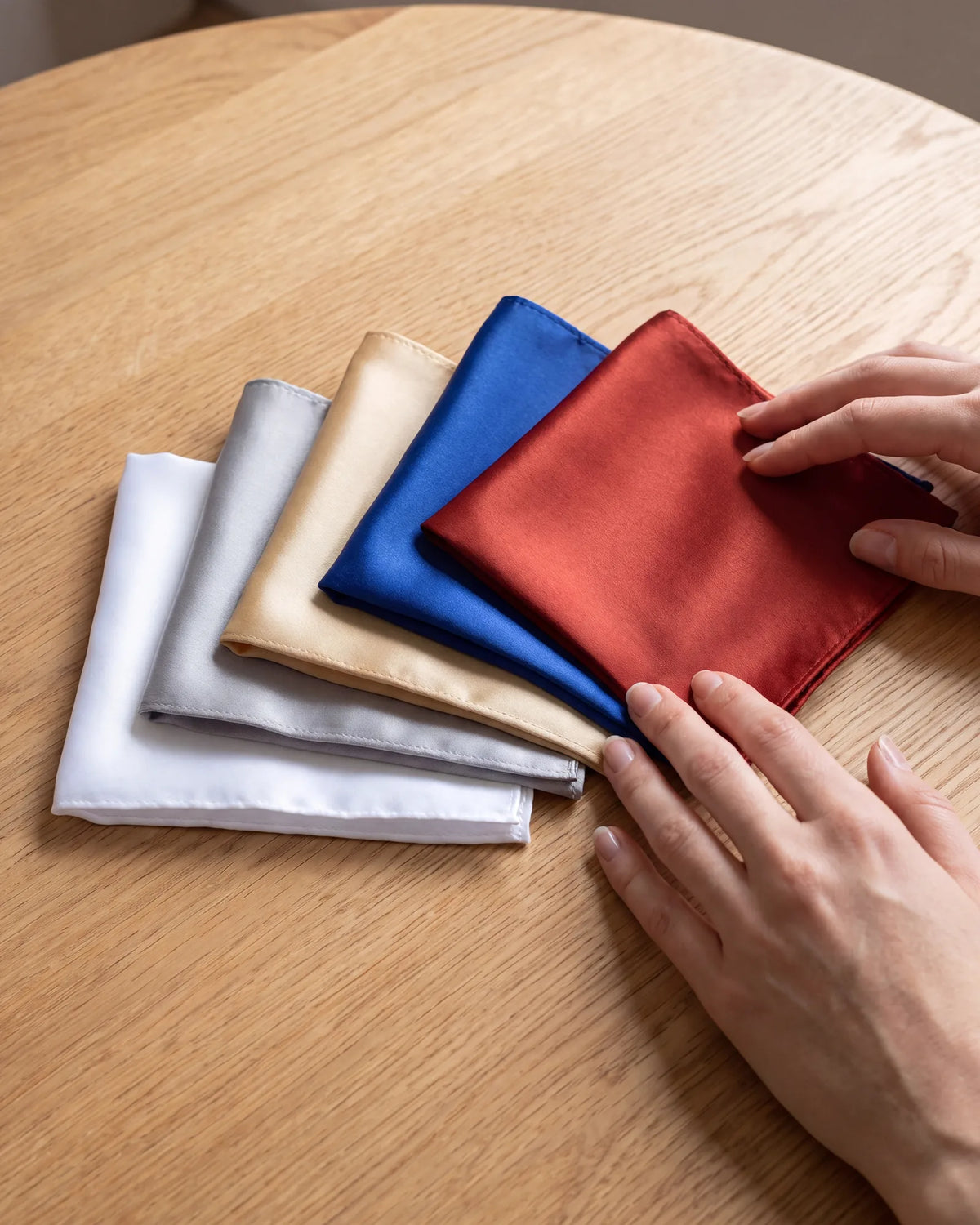 Buying satin squares? Plan on puffs and other soft folds. For a flat fold, satin needs a bigger square to stay up.