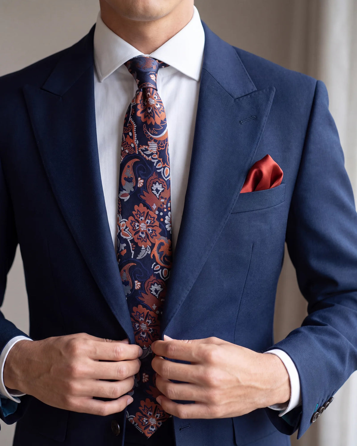 Bold tie? Keep the square plain, and pull its color from one of the quieter shades in the tie.