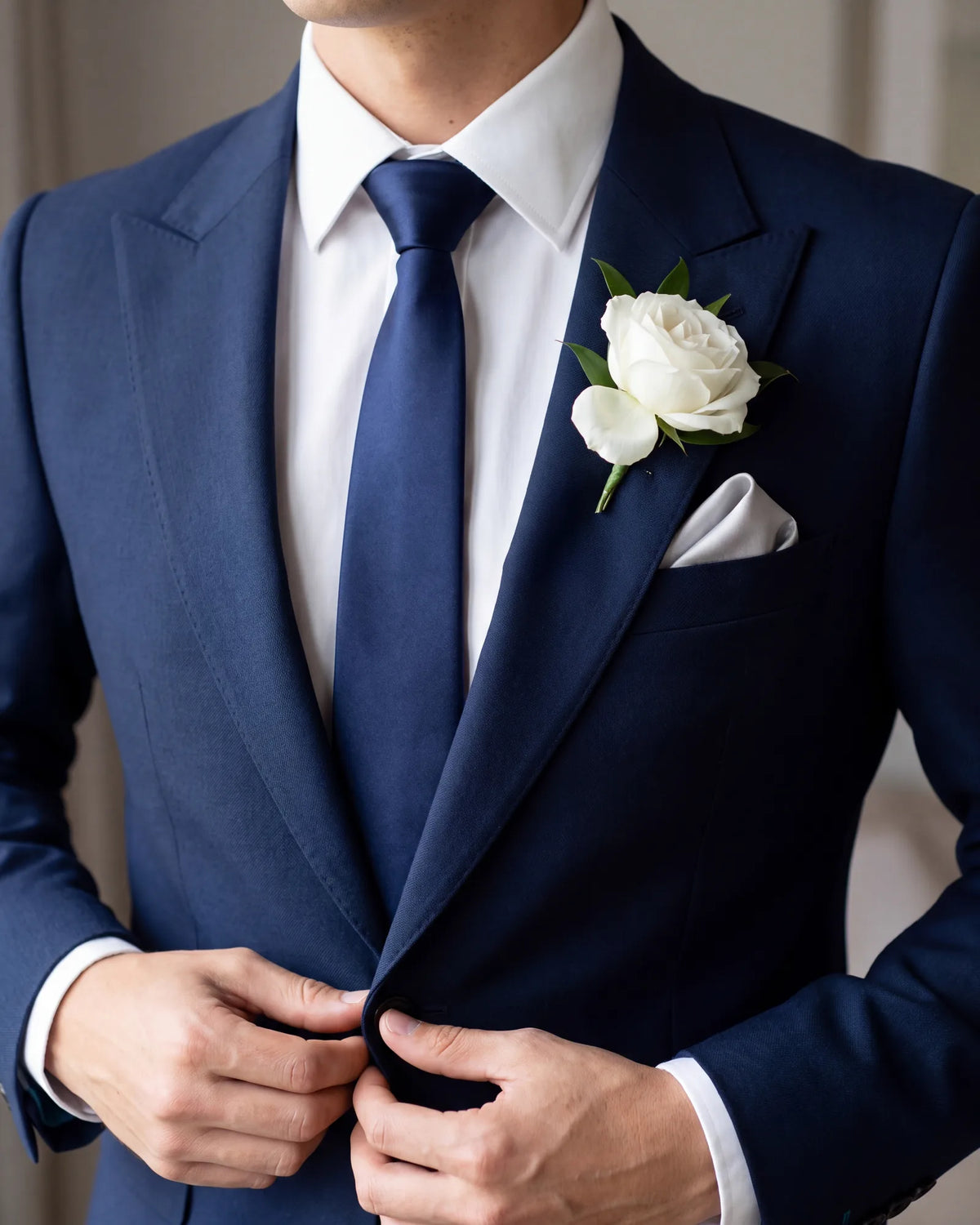 Wearing a boutonniere? Stick to a small presidential or one-point fold below it, and choose a square that suits the flower without matching it.