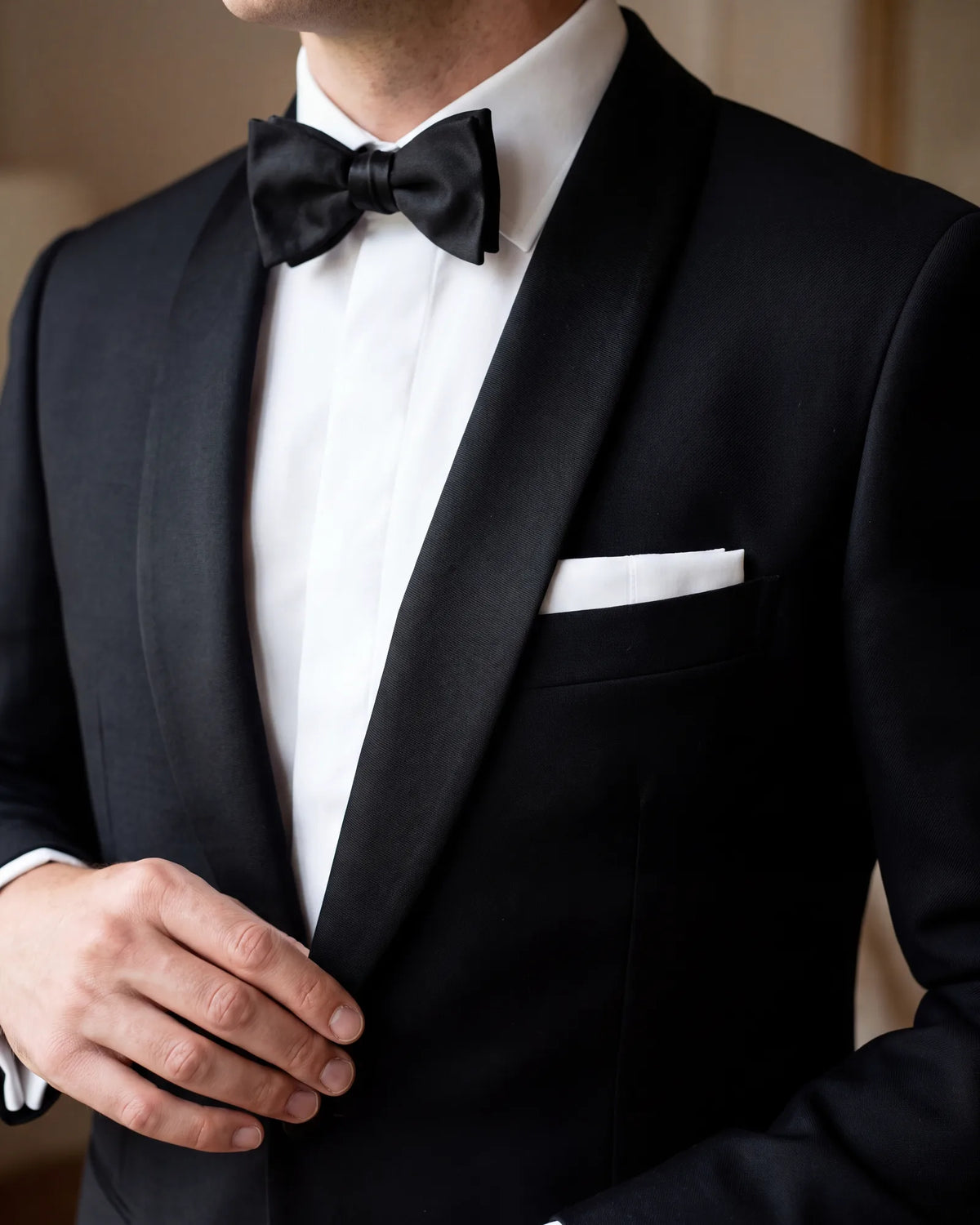At black tie, wear a white square in a presidential fold. Linen or cotton is the traditional cloth for it.