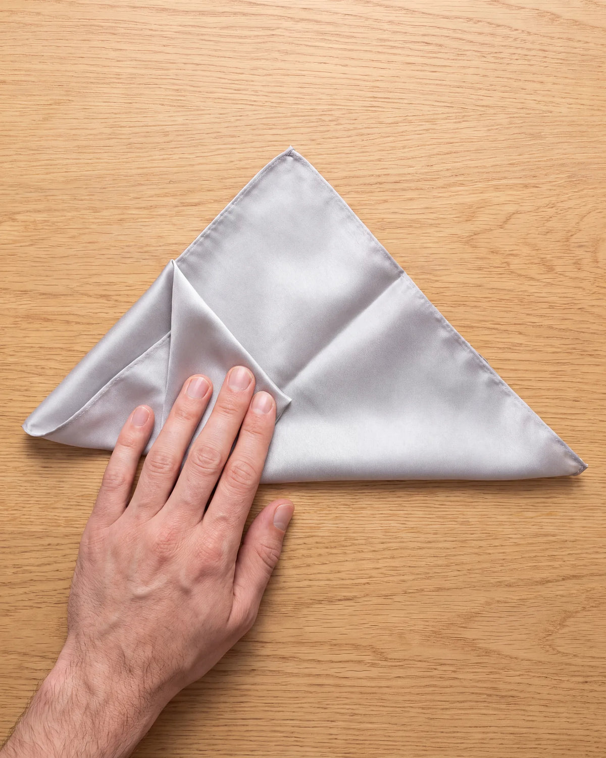 Bring the right corner across on top of the left one, stopping when the width fits your pocket.