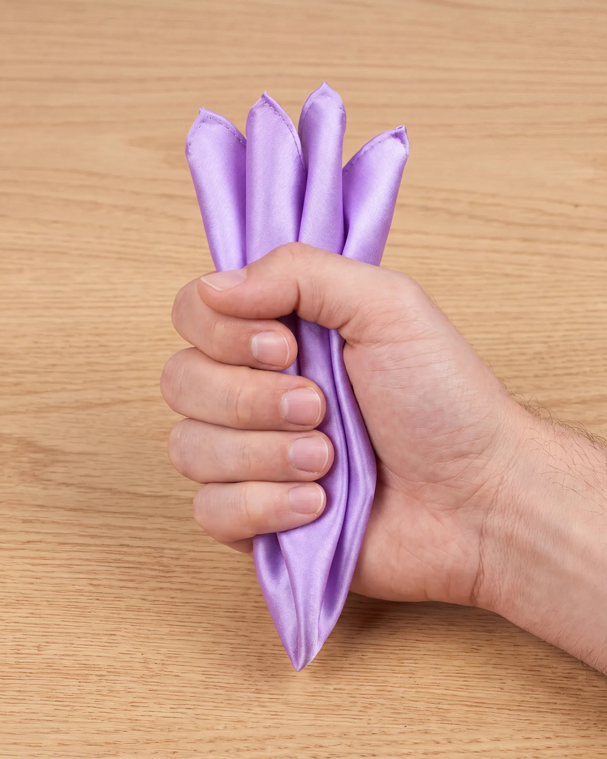 For the reverse puff, turn the gathered bundle over so the tips point up. Then fold the rounded end up behind them.