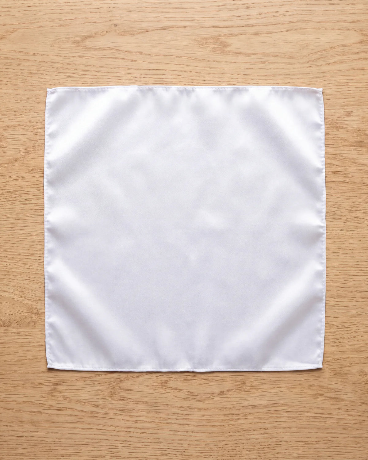 Lay the square out flat to start any fold. Silk, satin, linen, cotton and wool are the usual fabrics.