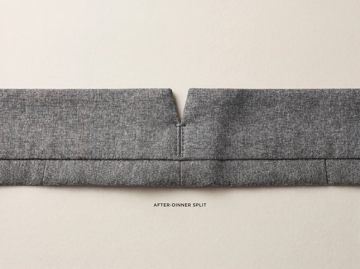 After-dinner split, the small V notch at the center-back waistband of grey wool suit trousers