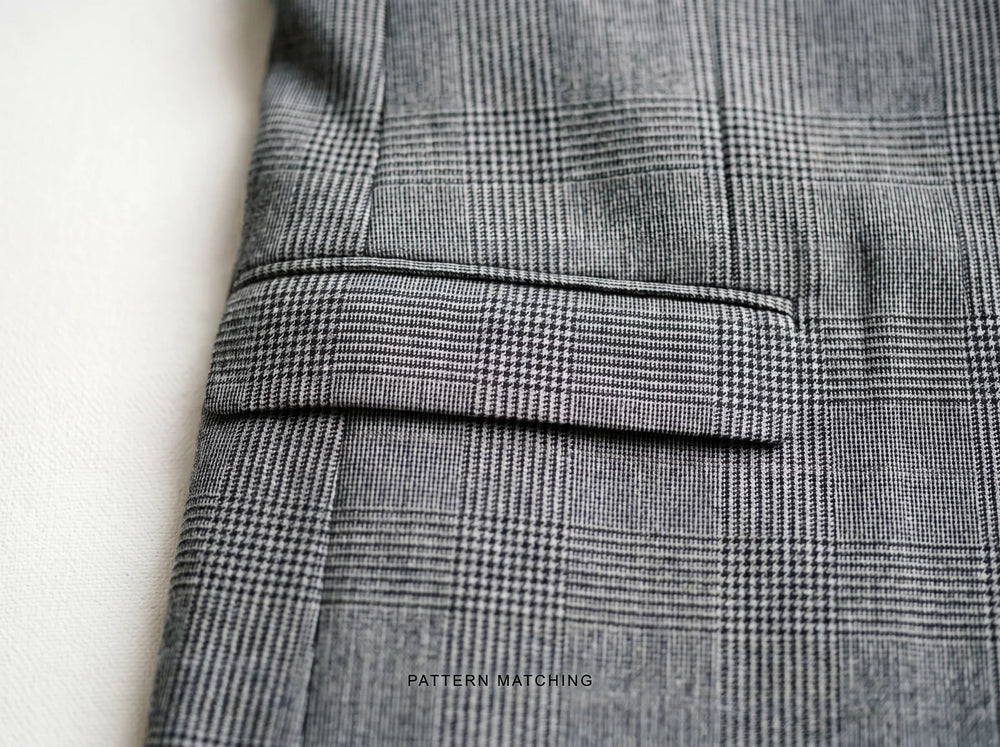 Glen-check suit with the pattern matched across the pocket flap and body seam