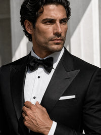 Black peak-lapel tuxedo with bow tie