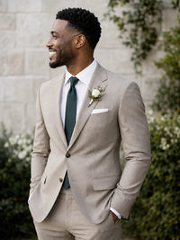 Tan suit with green tie and boutonniere