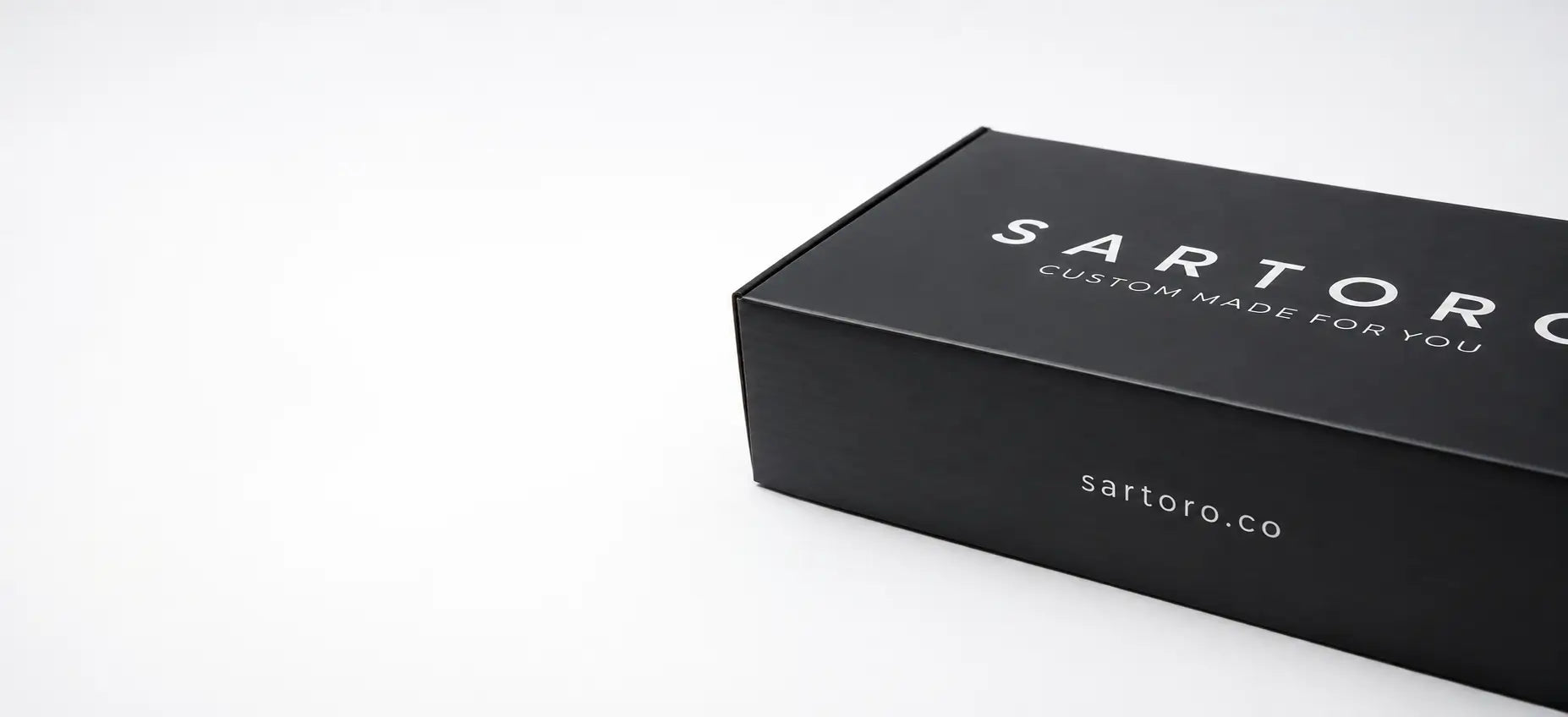 A black rectangular product box with white text reading 'SARTORO' and 'CUSTOM MADE FOR YOU' on a clean white background.