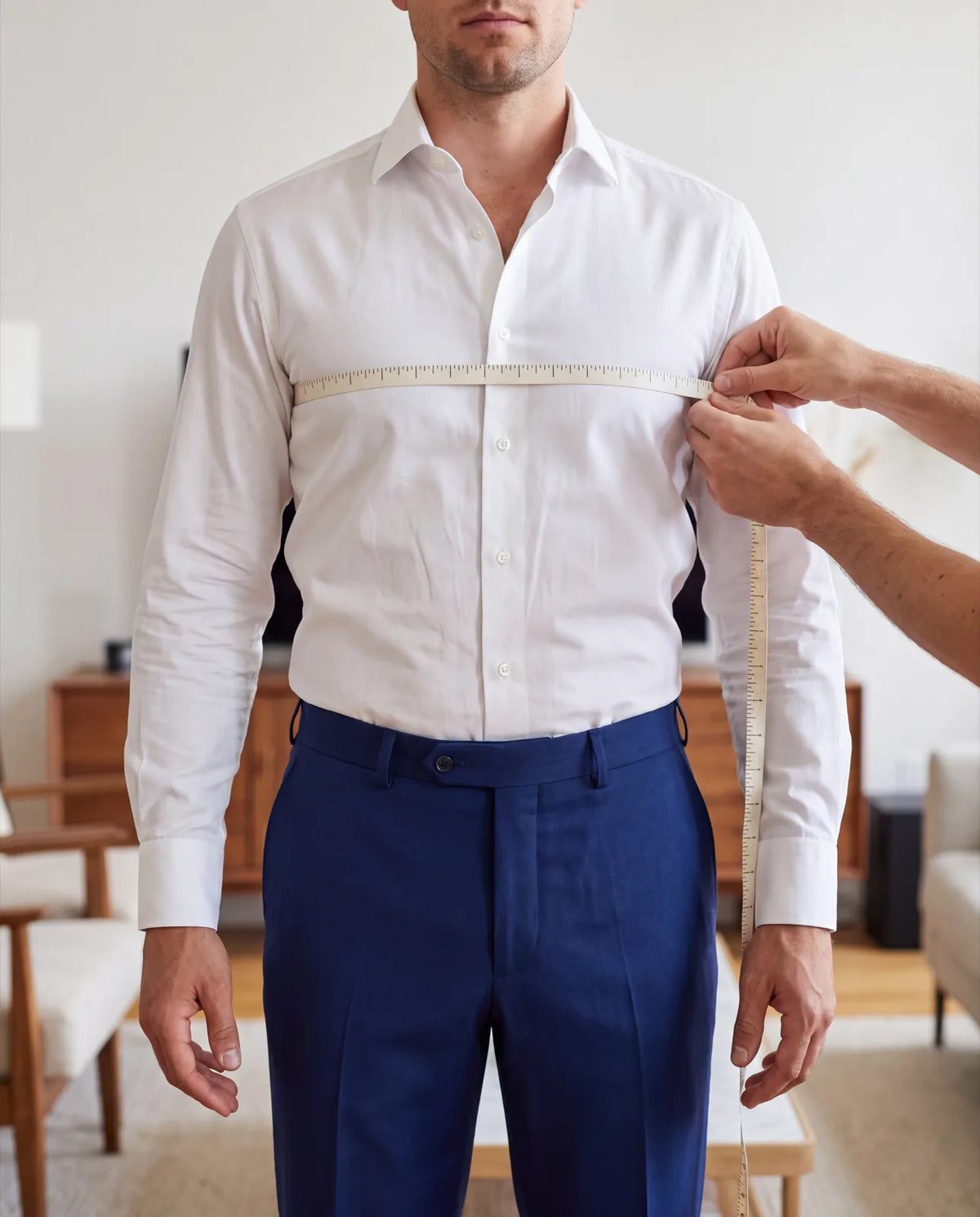 Have someone else hold the tape. Keep it level under your arms, over a thin shirt.