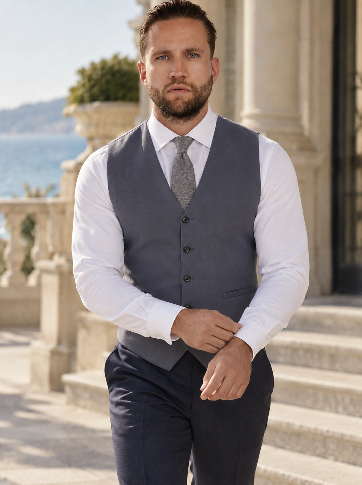 Shadow Grey Cotton Vest worn by a model, seafront hotel steps714