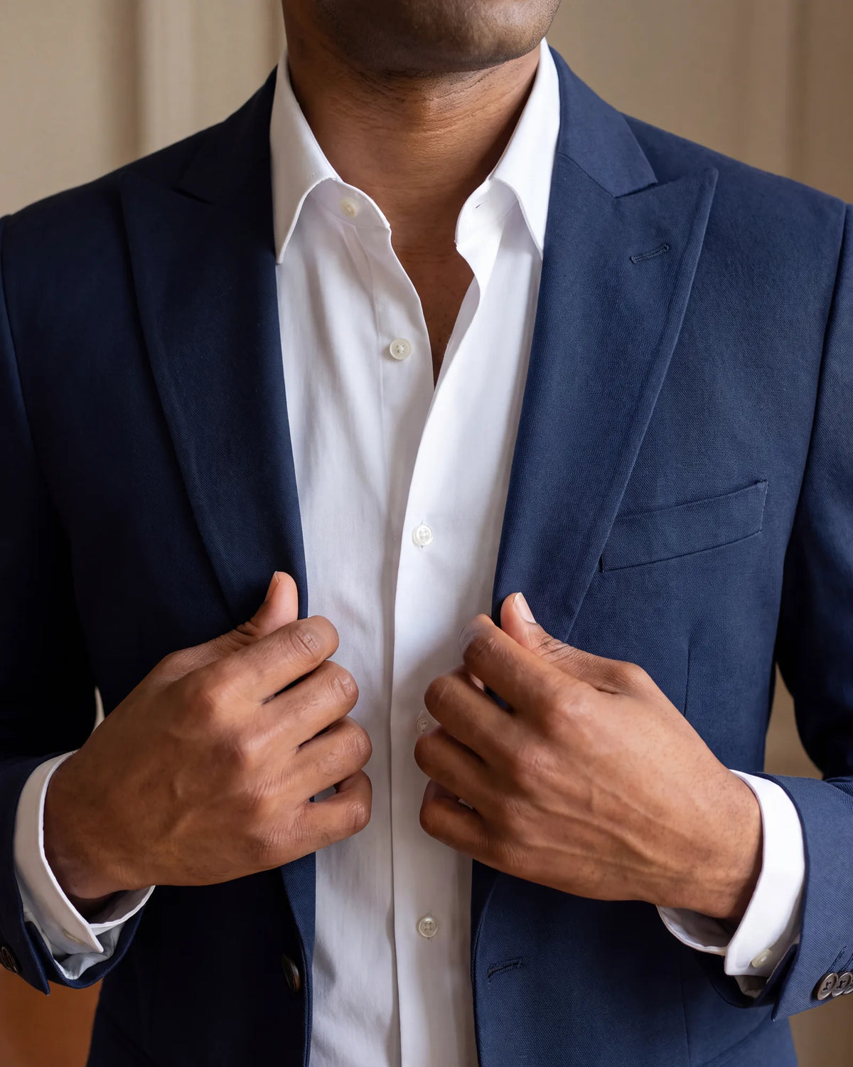 Aim a little above the middle. Smart casual sits above jeans and a t-shirt but below a suit and tie, so an open collar under a jacket fits.