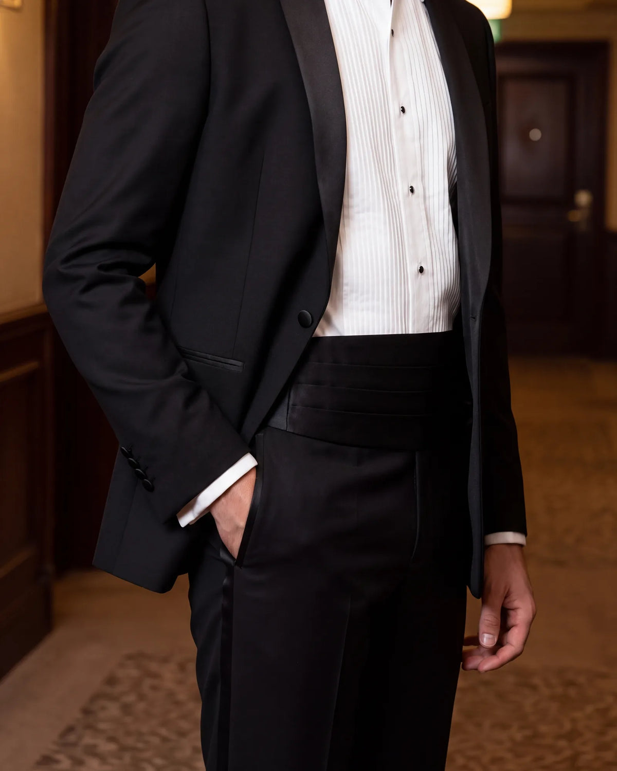 Try sitting down in it. With the higher rise and a cummerbund on, no shirt should show at the waist.
