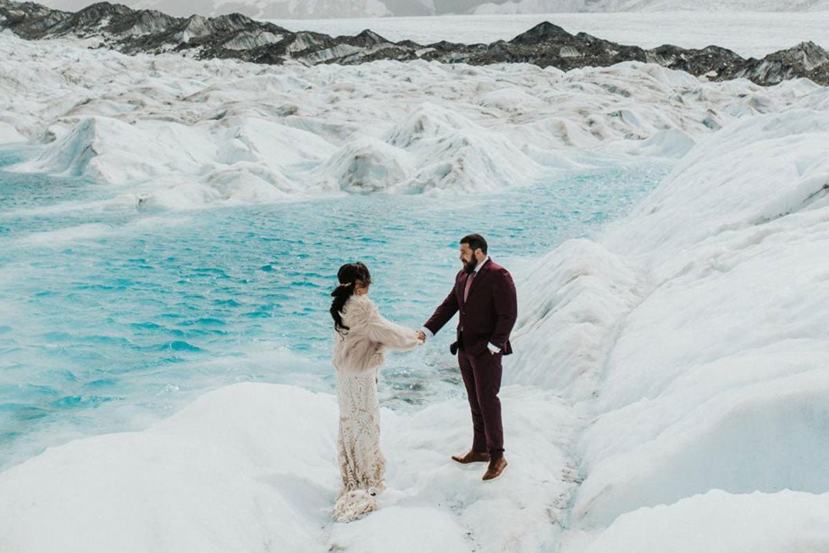 bride and groom shaking hands on a glacier in iceland