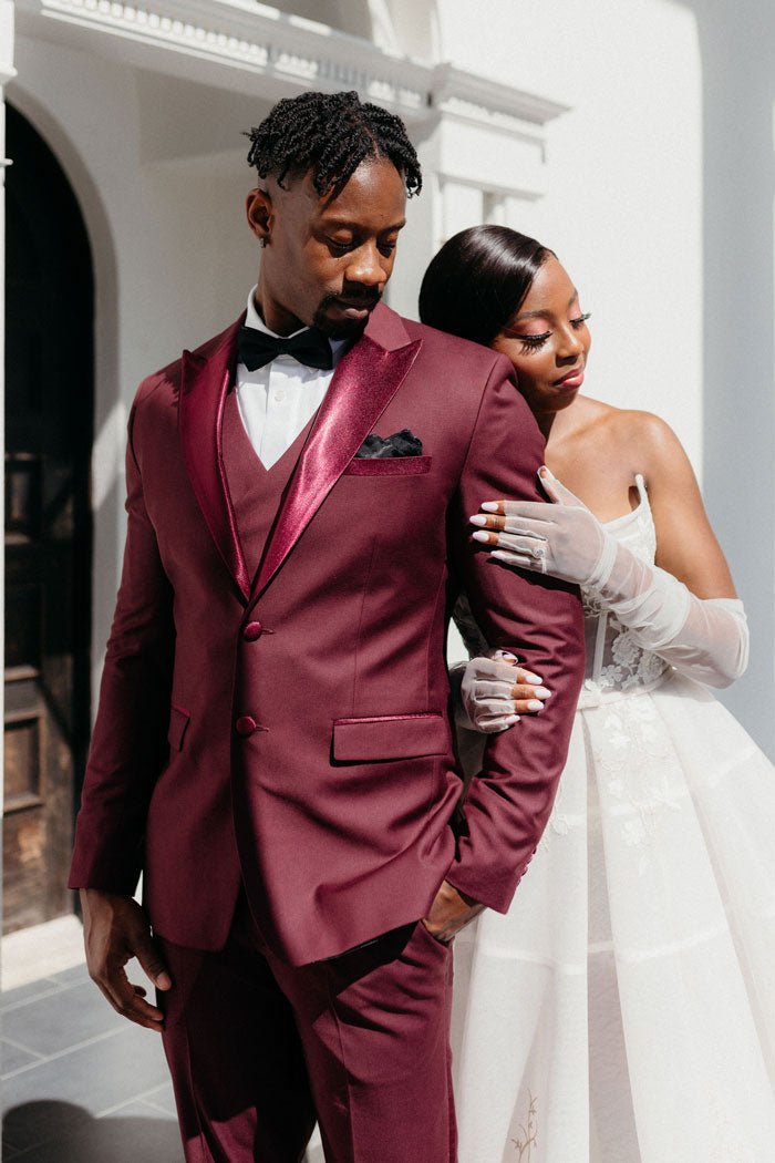 bride and groom in burgundy tuxedo