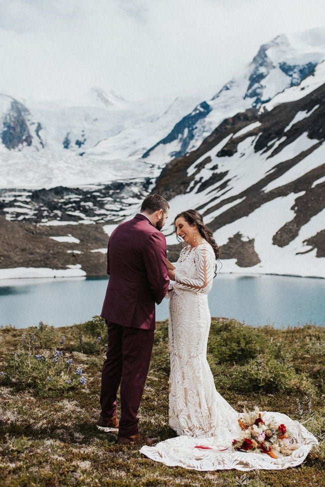 bride and groom exchanging rings overlooking a glacier lake