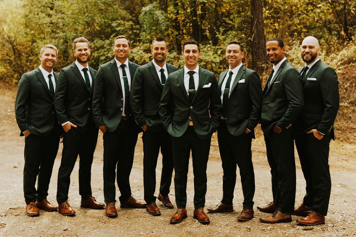 groom and 5 groomsmen posing in green suits