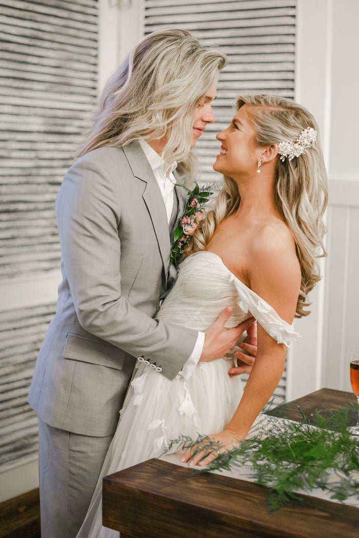 wedding couple embracing over a table