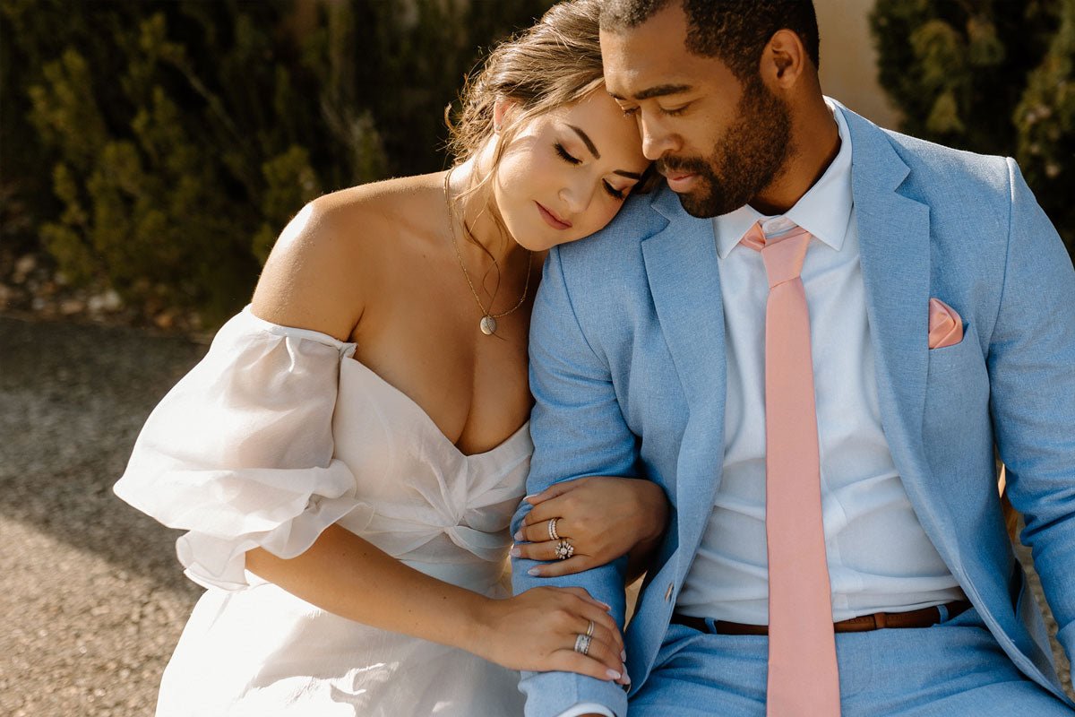 bride resting her head on the grooms shoulder while they both sit in chairs