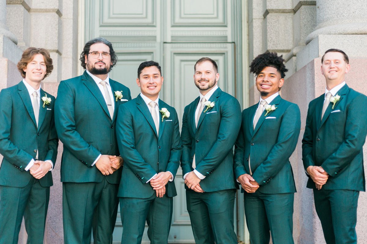 groomsmen in green suits standing together