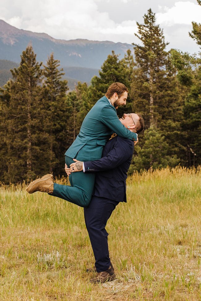 two grooms embracing in a big hug