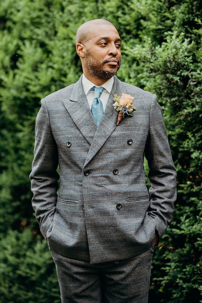 groom adjusting his blue suit