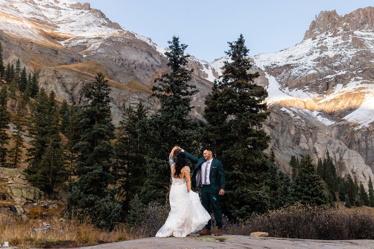 bride and groom dancing in a mountain valley