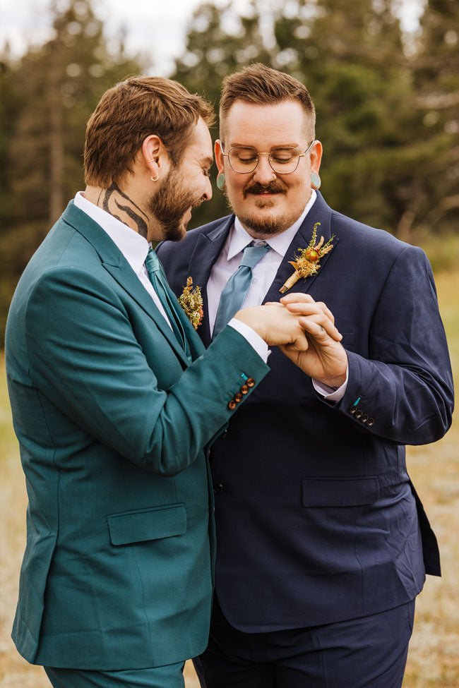 two grooms in green and blue suits