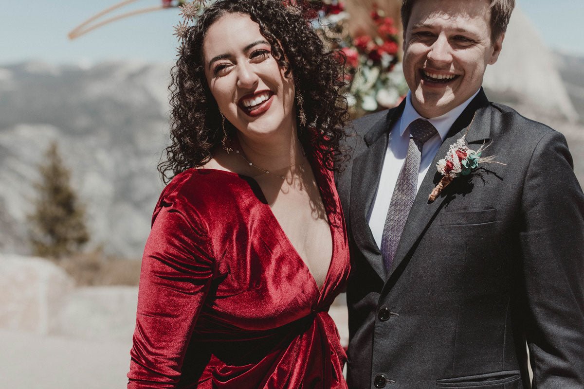 bride and groom being cheered on by the wedding party while they walk through the lawn