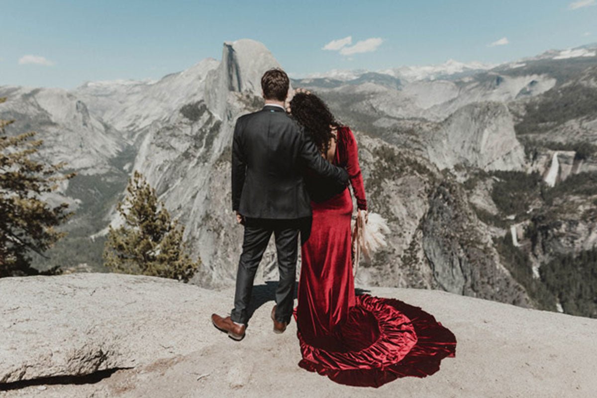bride and groom being cheered on by the wedding party while they walk through the lawn