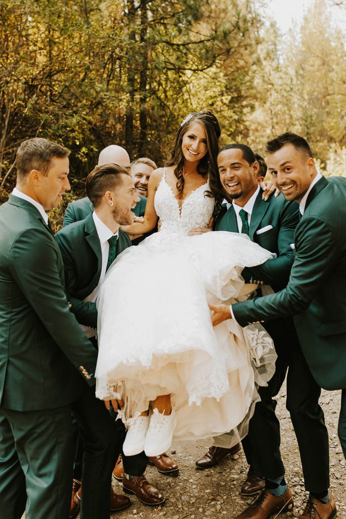 wedding party in green suits with bride
