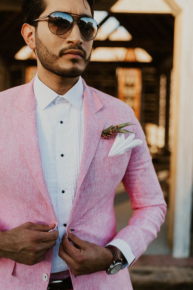 groom close up in his pink suit