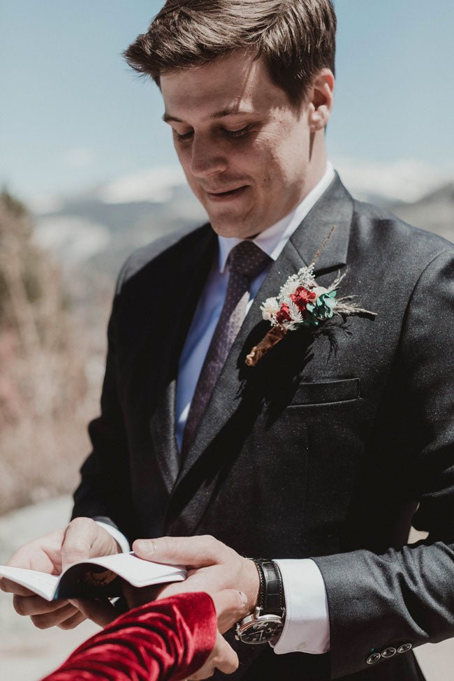 groom adjusting his blue suit